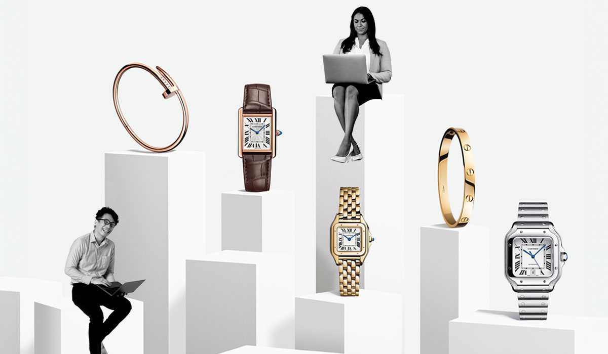 A series of Cartier watches on stands of different heights next to happy employees.